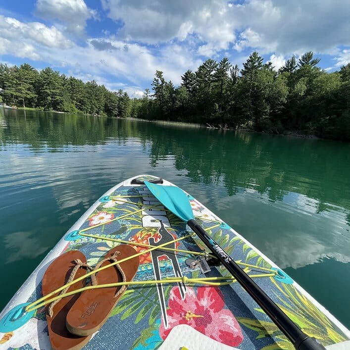 Drift paddle board floating lazily in a lake on a cloudy day