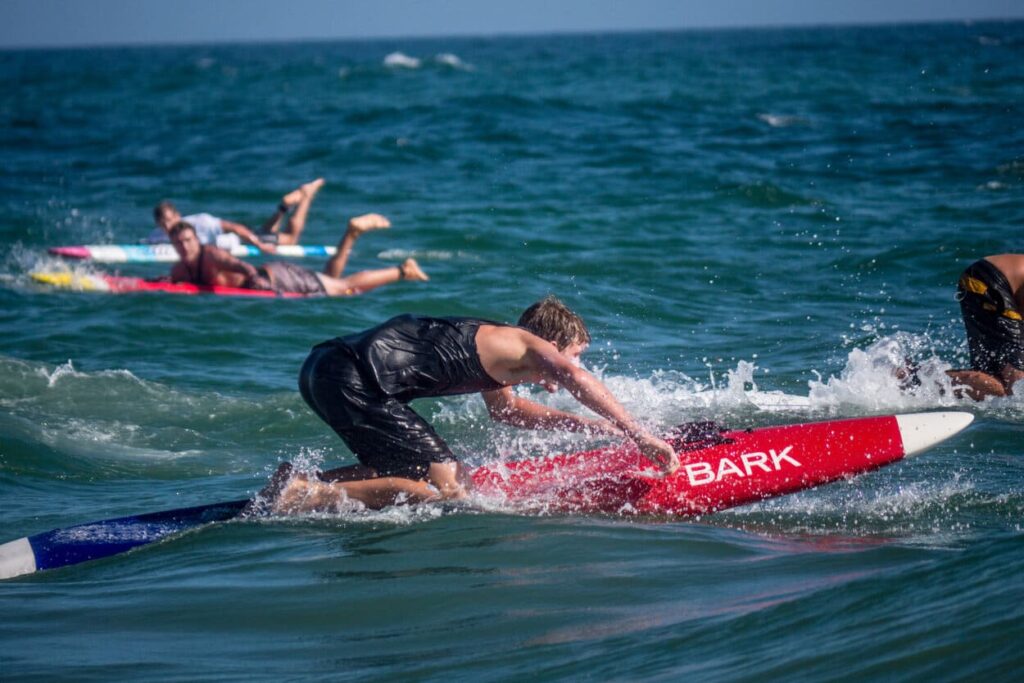 racing paddle board with a man on it in the water