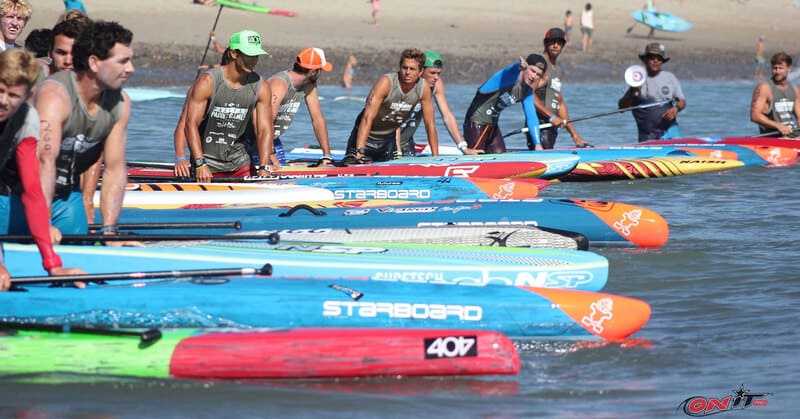 racing paddle board sups on the water with men lining up to race